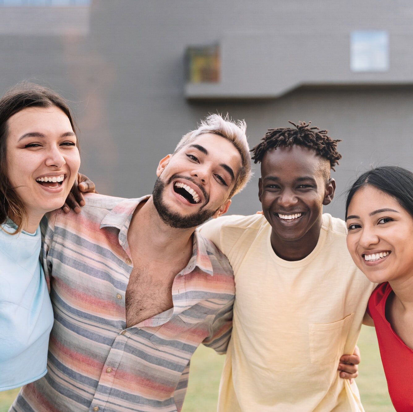 young diverse multi-ethnic friends enjoying good moments and having fun together outdoors